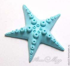 a starfish made out of plastic beads on a white surface