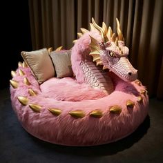 a pink dragon bed with gold spikes on it