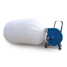 a white bag sitting on top of a blue hand truck next to a large pillow