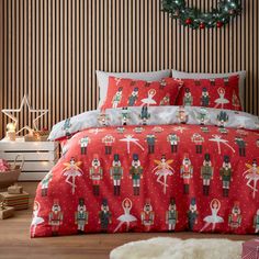 a red bed with nutcrackers and snowmen on it