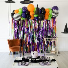 a party with balloons and streamers on the wall