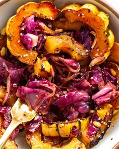 a white bowl filled with red cabbage and squash