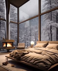 a large bed sitting in front of a window next to a fire place on top of a wooden floor