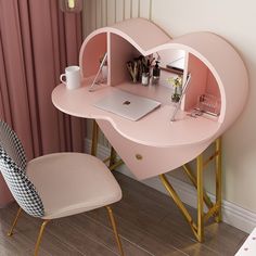 a heart shaped desk with a laptop on it and a chair in front of it