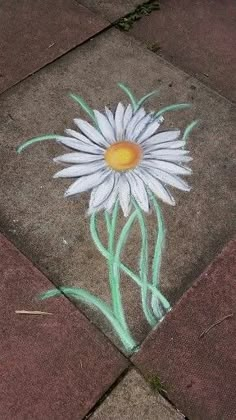 a sidewalk with a painted daisy on it