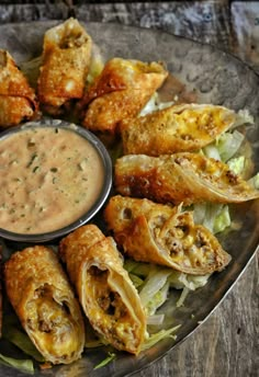 a plate filled with food and dipping sauce