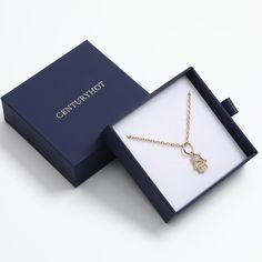 a necklace in a box with the word congratulations written on it and a gold chain