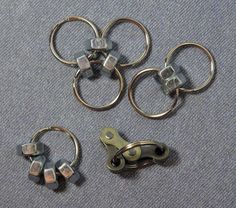 four pairs of metal scissors on carpeted area with clippings attached to them