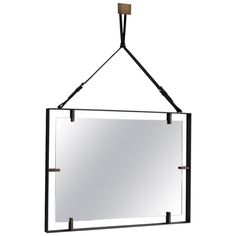 a rectangular mirror hanging from a metal frame