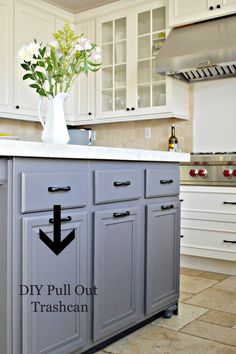 a kitchen island with an arrow pointing to pull out trashcan