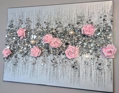 some pink roses are on a silver and white background with sequins in the middle