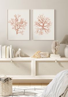 two pink corals are on the wall above a white shelf in a room with a bed