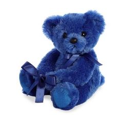 a blue teddy bear with a bow on it's neck and eyes, sitting against a white background