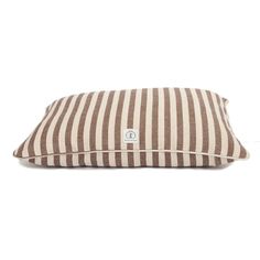 a brown and white striped dog pillow on a white background with the letter c in it