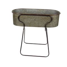 a metal planter sitting on top of a stand