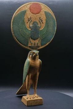 an egyptian statue with a bird on it's head