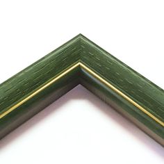 the corner of a green wooden frame on a white background with gold trimmings