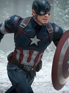 a man dressed as captain america running through the snow