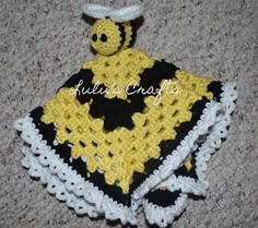 a yellow and black crocheted blanket with a bee on it