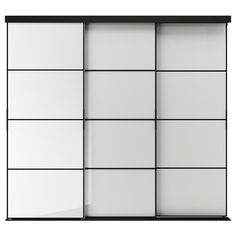 a white and black sliding closet door with glass panels on the bottom, and two shelves below