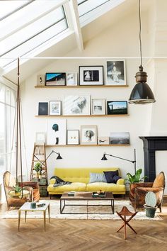 a living room filled with furniture and pictures on the wall