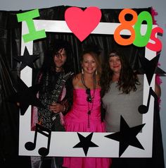 three people standing in front of a photo frame with the words 80s's on it