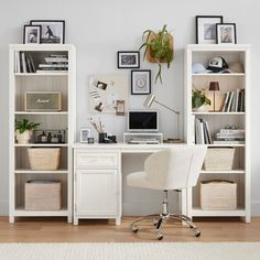 a white desk with a computer on top of it next to a bookcase filled with books