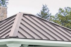 a brown metal roof on a white house