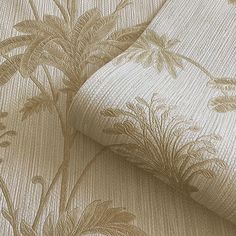 a close up view of a wallpaper with flowers and leaves in gold on white