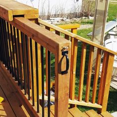 a pair of scissors is on the rail of a wooden deck