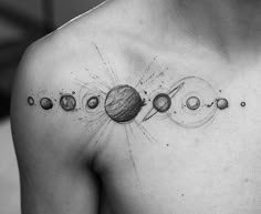 a man's chest with the solar system on it