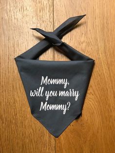 a black bandana with the words mommy, will you marry mommy? on it