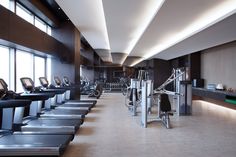 an empty gym with treadmills and machines