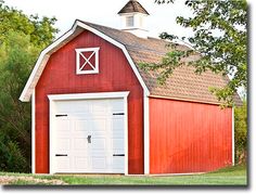 a red barn with a white door and windows