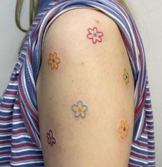 a woman with small flowers on her arm and shoulder, all over her left side