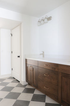 a bathroom with a checkered floor and white walls