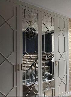 mirrored closet doors in a bedroom with white walls