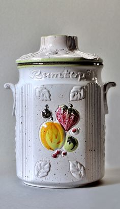 a white canister with some pictures on it