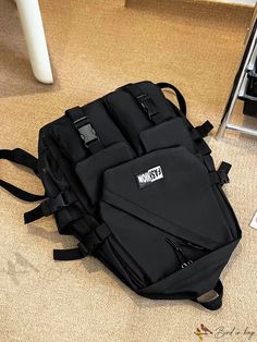 a black backpack sitting on the floor