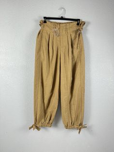 Elevate your wardrobe with these Free People Women's Every Day's A Dream Tie Pants in Bronze Combo. These pants are perfect for any occasion and feature a hook & eye closure, pleated front, and wide leg/harem leg style. The camel color and brown exterior color make these pants a versatile addition to any outfit. Crafted from a blend of polyester and wool, these pants are both comfortable and durable. The relaxed fit and high rise design ensure a flattering silhouette. These pants also feature ties as accents and pockets for added convenience. Perfect for anyone who wants to add a touch of metal to their wardrobe, these cropped pants are a must-have for any fashion-forward woman. Bohemian Wardrobe, Tie Pants, People Women, Brown Pants, Inspo Board, Camel Color, Hook Eye, Cropped Pants, Special Event