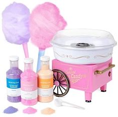 the cotton candy machine is pink and has two lollipops on it