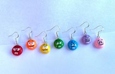 Candy M&M resin dangle earrings. 16mm. Stainless steel ear wire hook. Hypoallergenic. Great for those with sensitive ears! Many different colors available! Please reference the photos to choose a M&M color. (Colors may vary slightly from photos.) I put a lot of time and effort into researching and purchasing the best products to provide quality jewelry at a great price. Due to the nature of these items, I will not be accepting returns or exchanges for any earrings. I do not want to risk reselling a pair of earrings that have potentially been worn. If there are any issues with the product, please contact me for a resolution. Candy Earrings, M M Candy, Earrings Cute, Trendy Earrings, Fun Earrings, Sensitive Ears, Cute Earrings, Best Products, Ear Wire