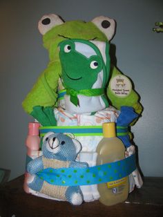 a stuffed animal sitting on top of a diaper filled with baby items next to a bottle