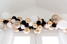 the balloon garland is hanging from the ceiling