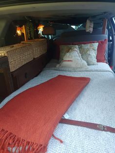 the back end of a vehicle with two beds in it