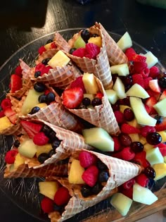 fruit and waffle cones are arranged on a glass platter, ready to be eaten