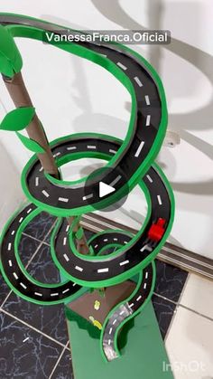 a green and black road model with trees on it