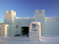 the entrance to an ice hotel is covered in snow