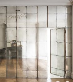 an empty room with mirrored walls and wooden floors