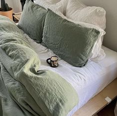 a bed that has some pillows on top of it and a pair of slippers